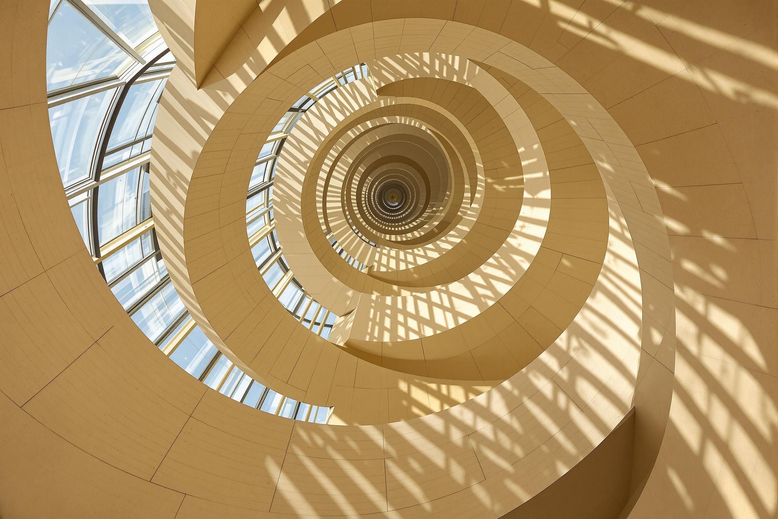 Spiral Stairs in Sunlit Patterns