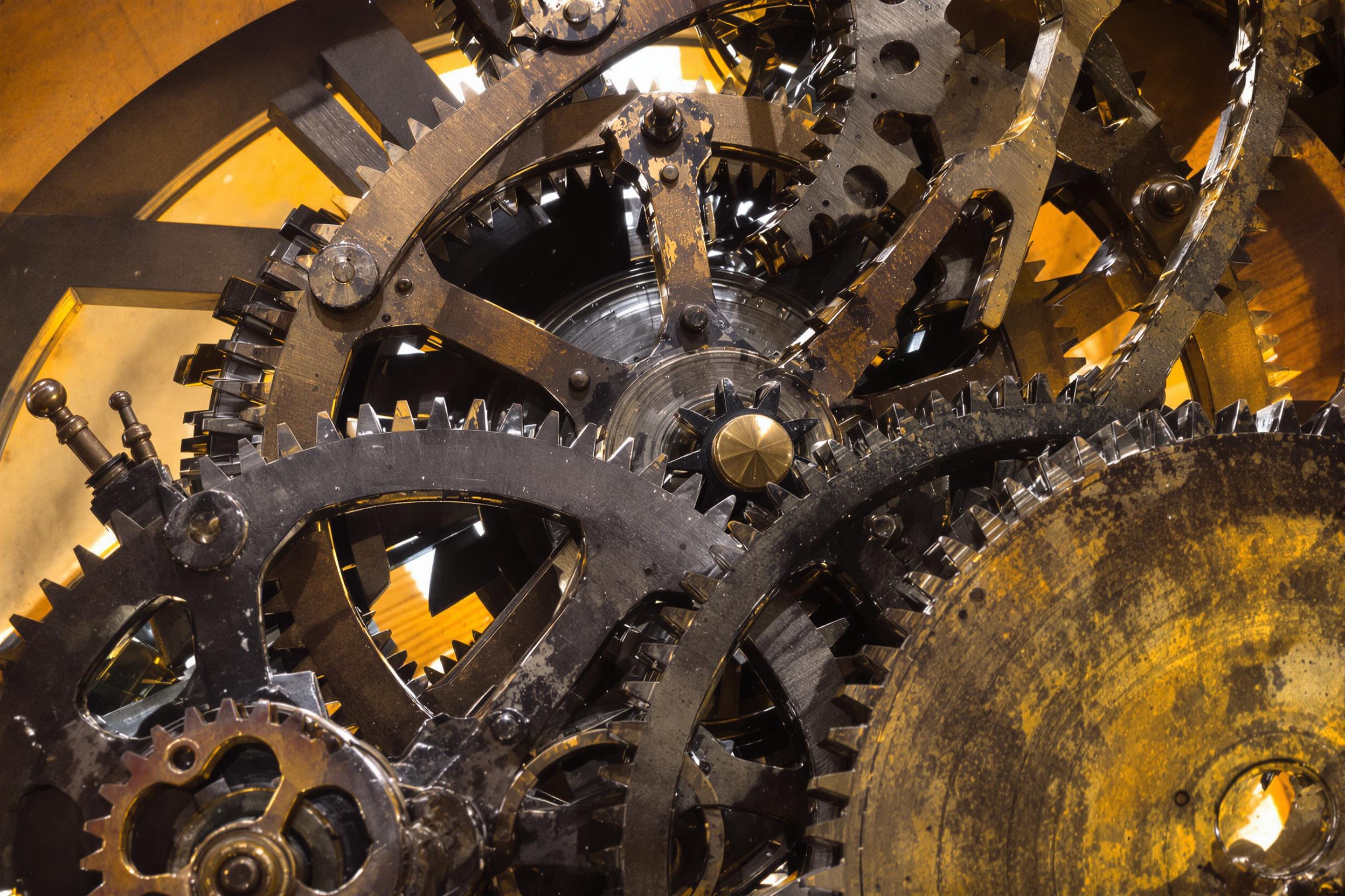 Timeworn Clock Tower Gears Exposed in Warm Light