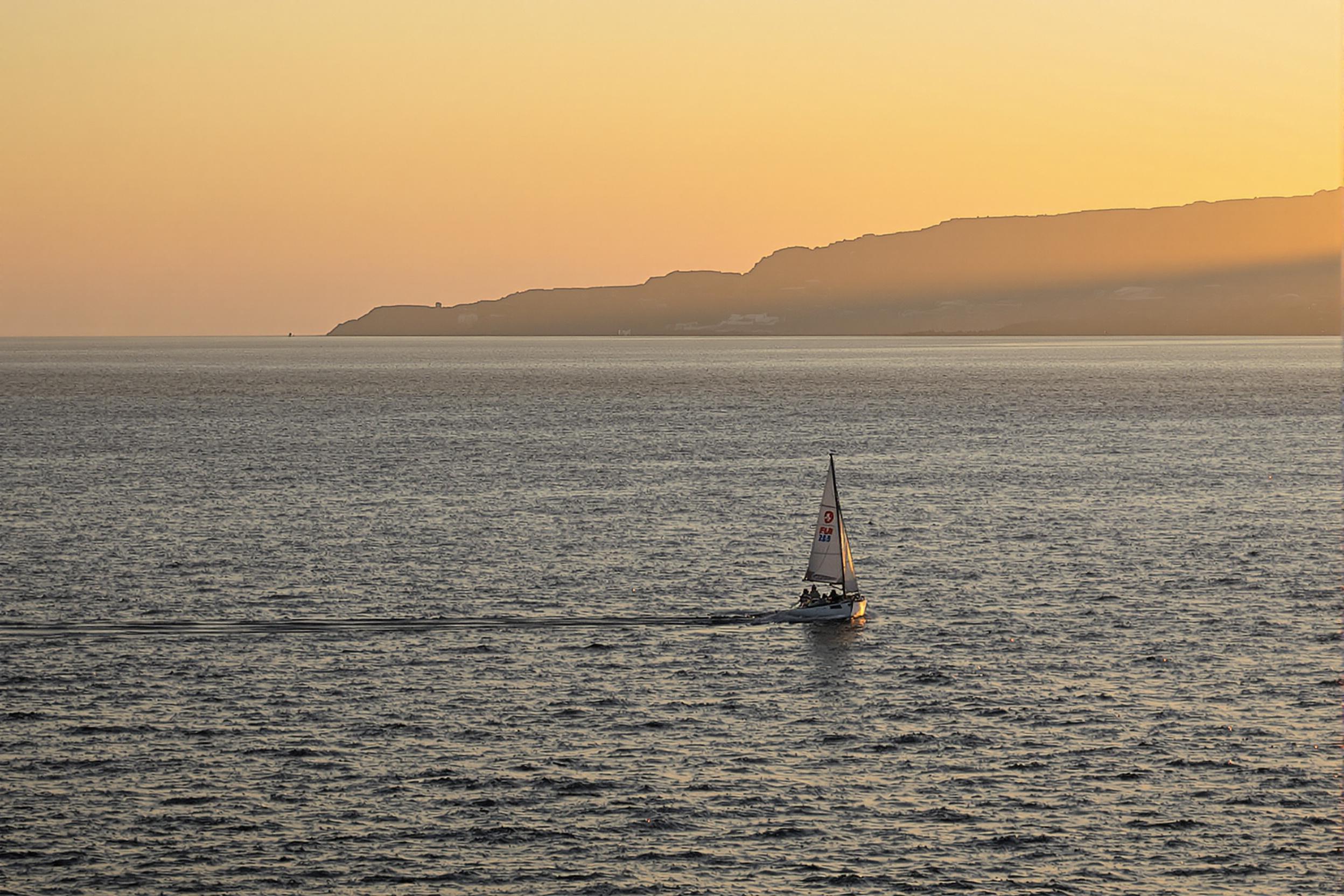 Lone Sailing Boat at Golden Hour