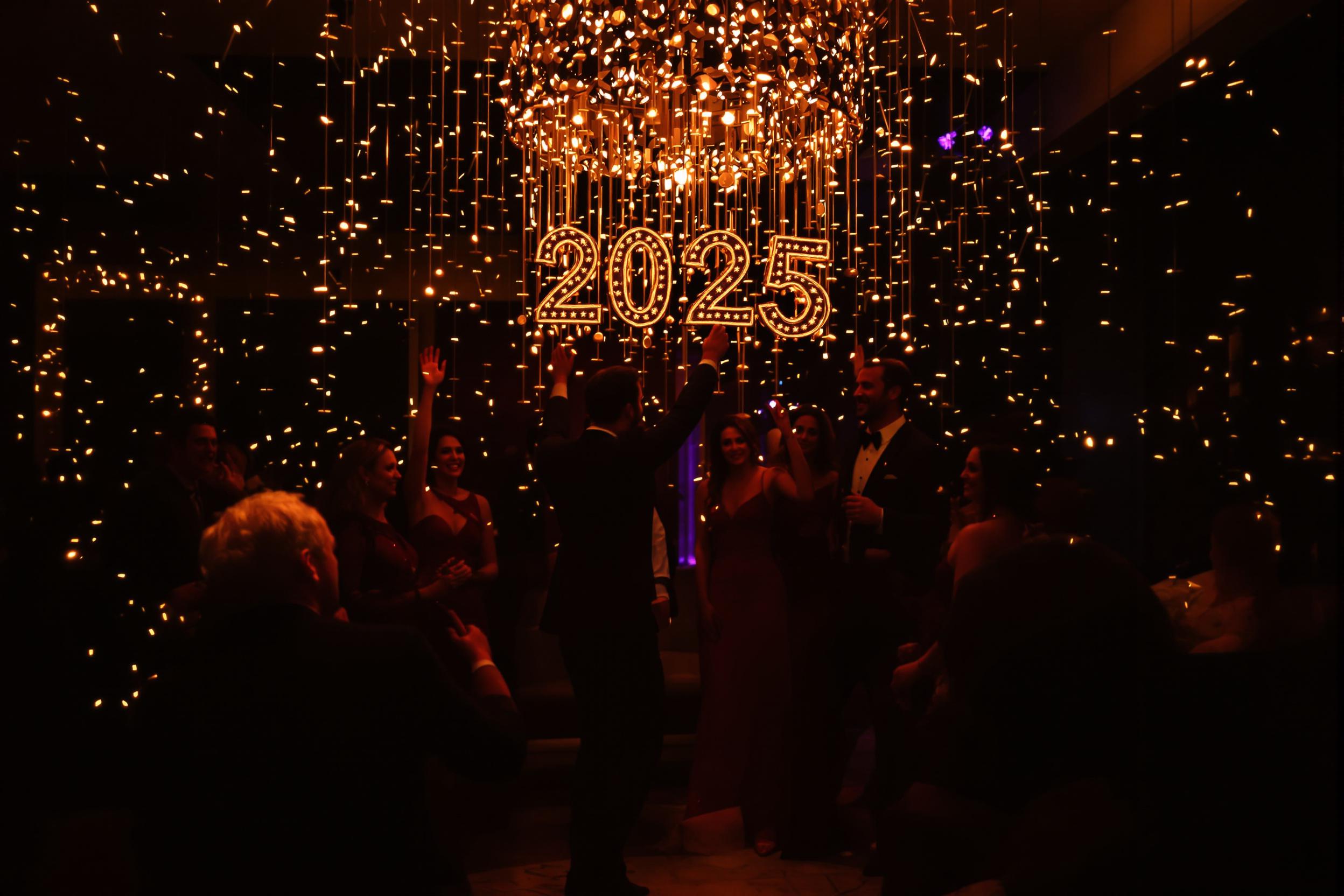 Stylish Friends Dancing Under Crystal Chandelier