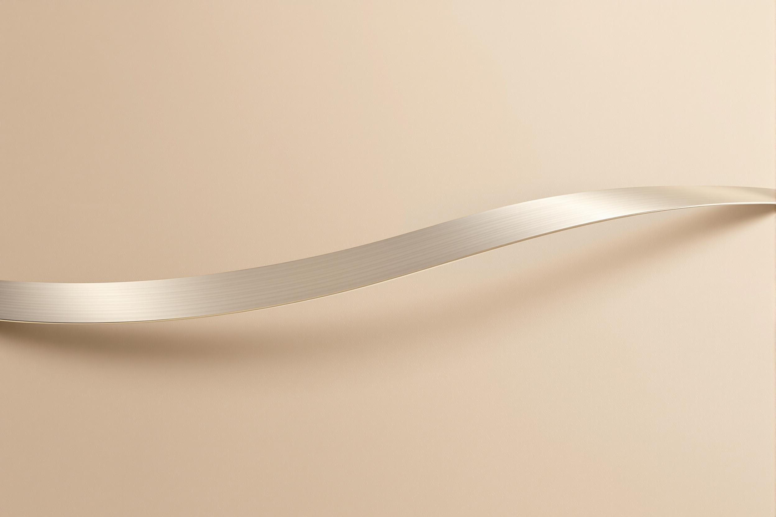 Bent Brushed Steel Strip Against Beige Background