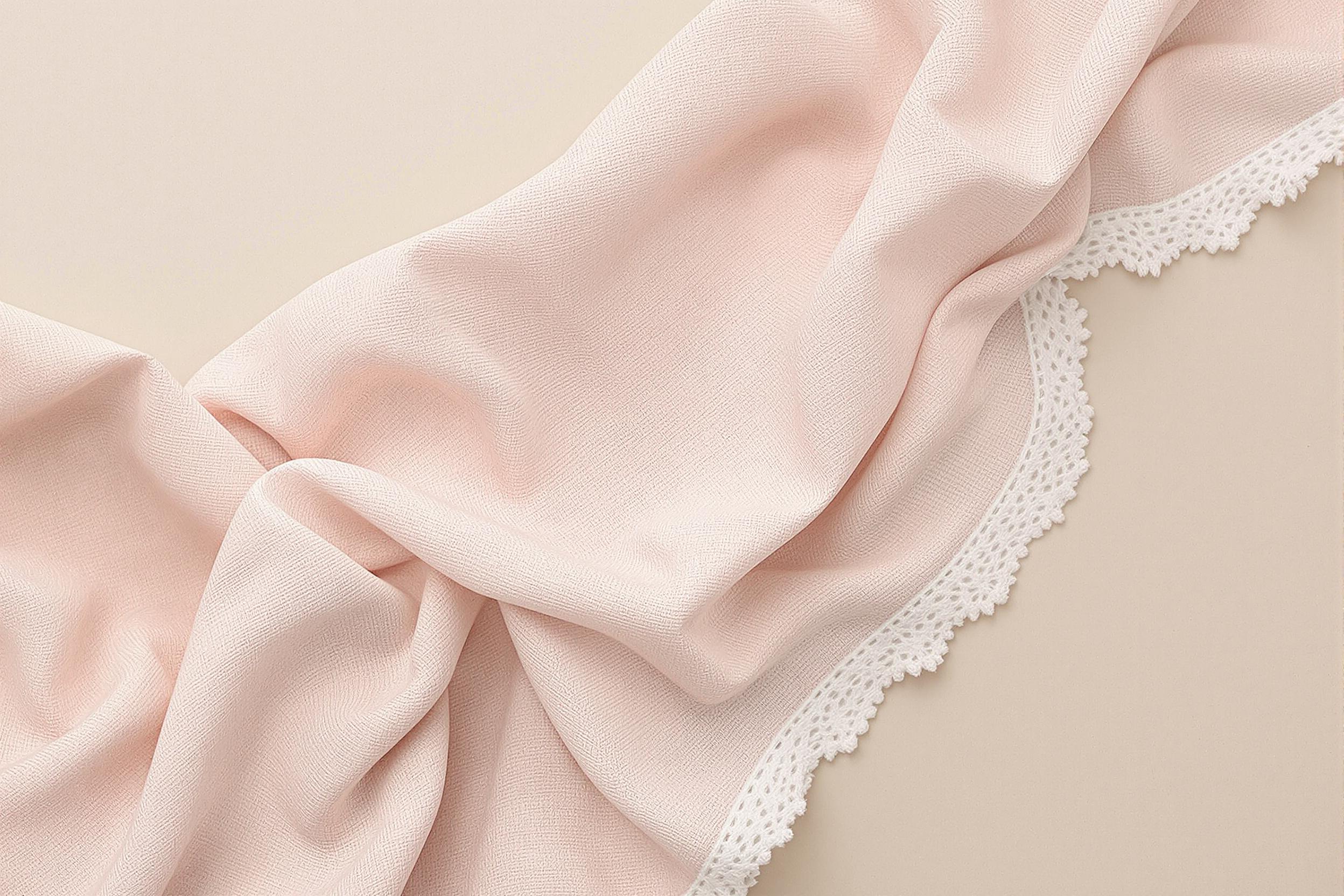 Pastel pink woven napkin on beige backdrop