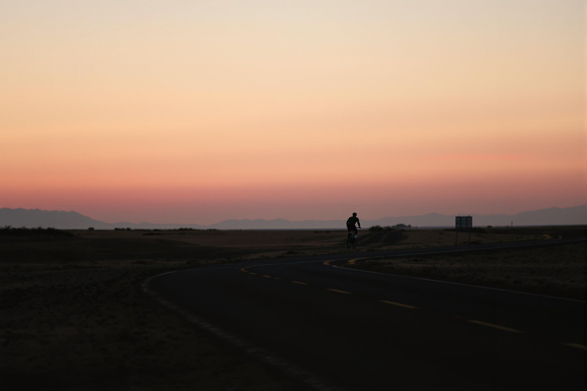 Minimalist Silhouette: Lone Cyclist on Horizon