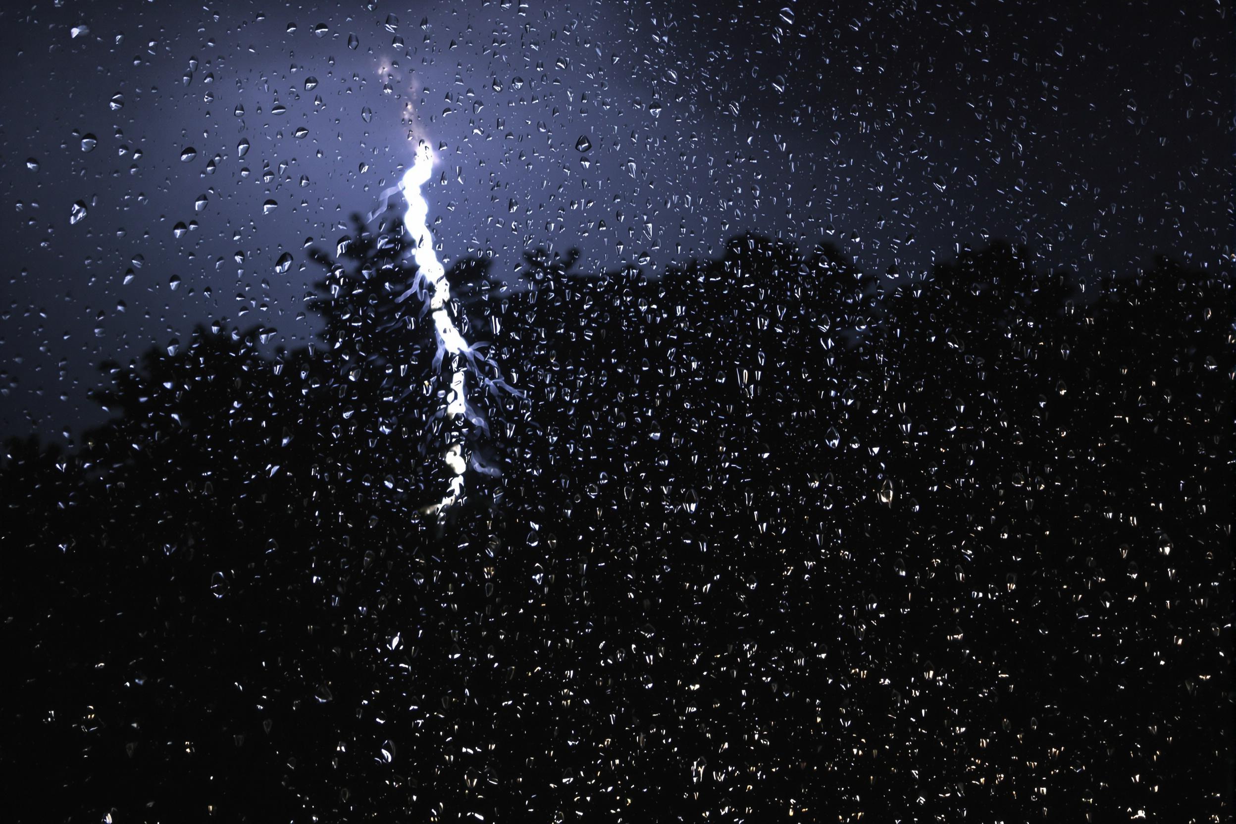 Rain-Streaked Window with Lightning