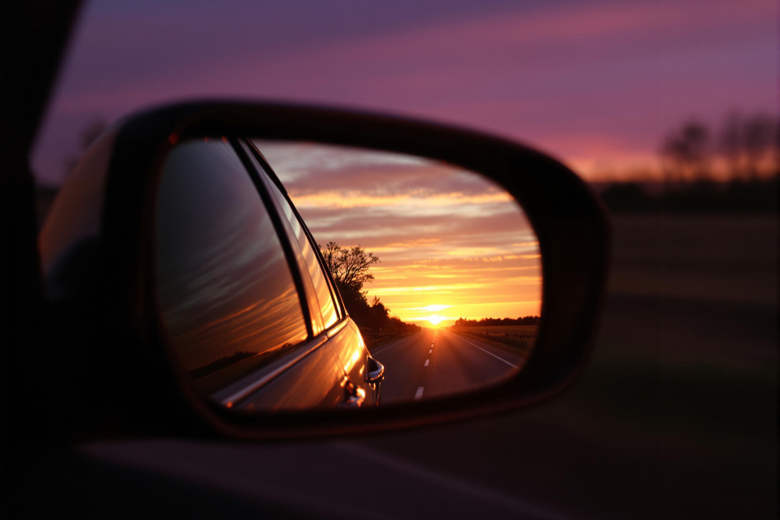 Golden sunset through rearview mirror