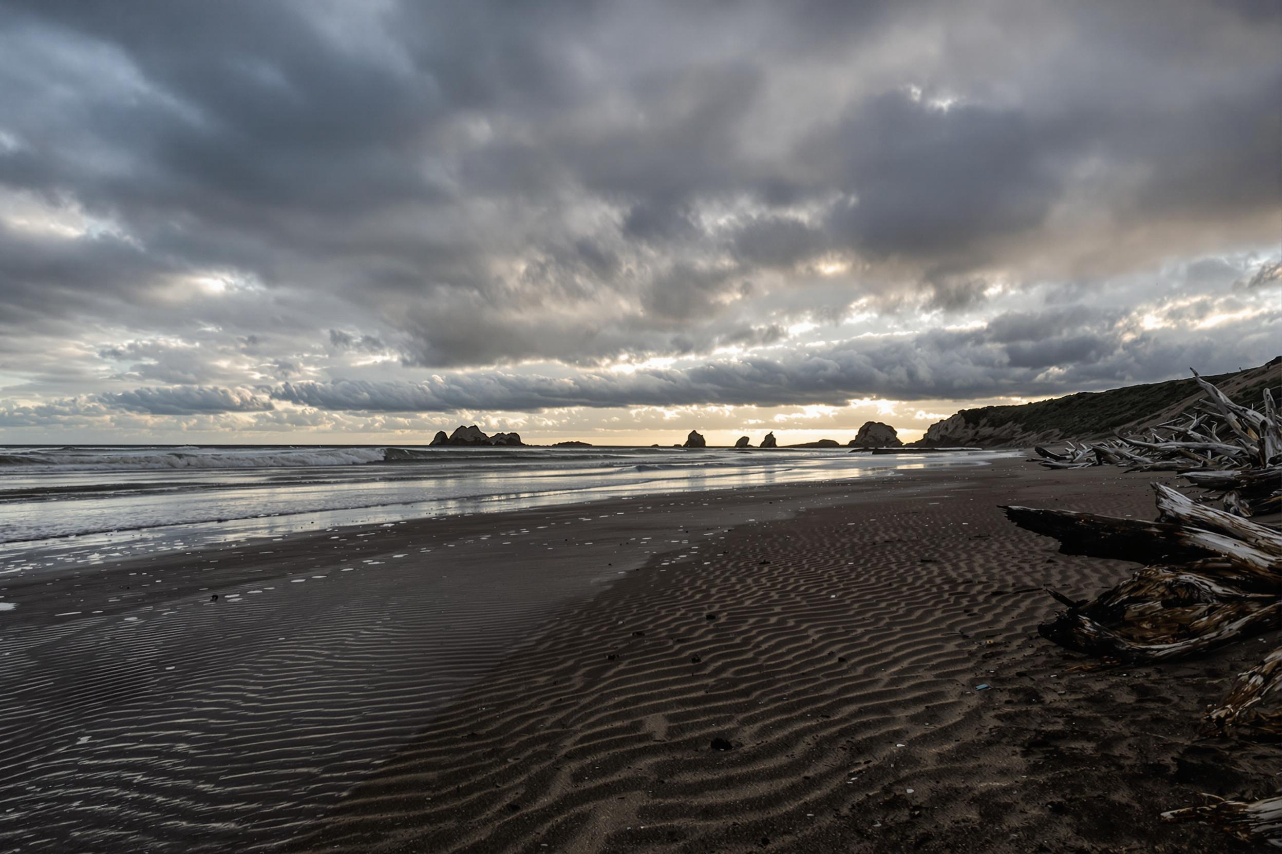 Secluded Beach Under Dramatic Storm Clouds