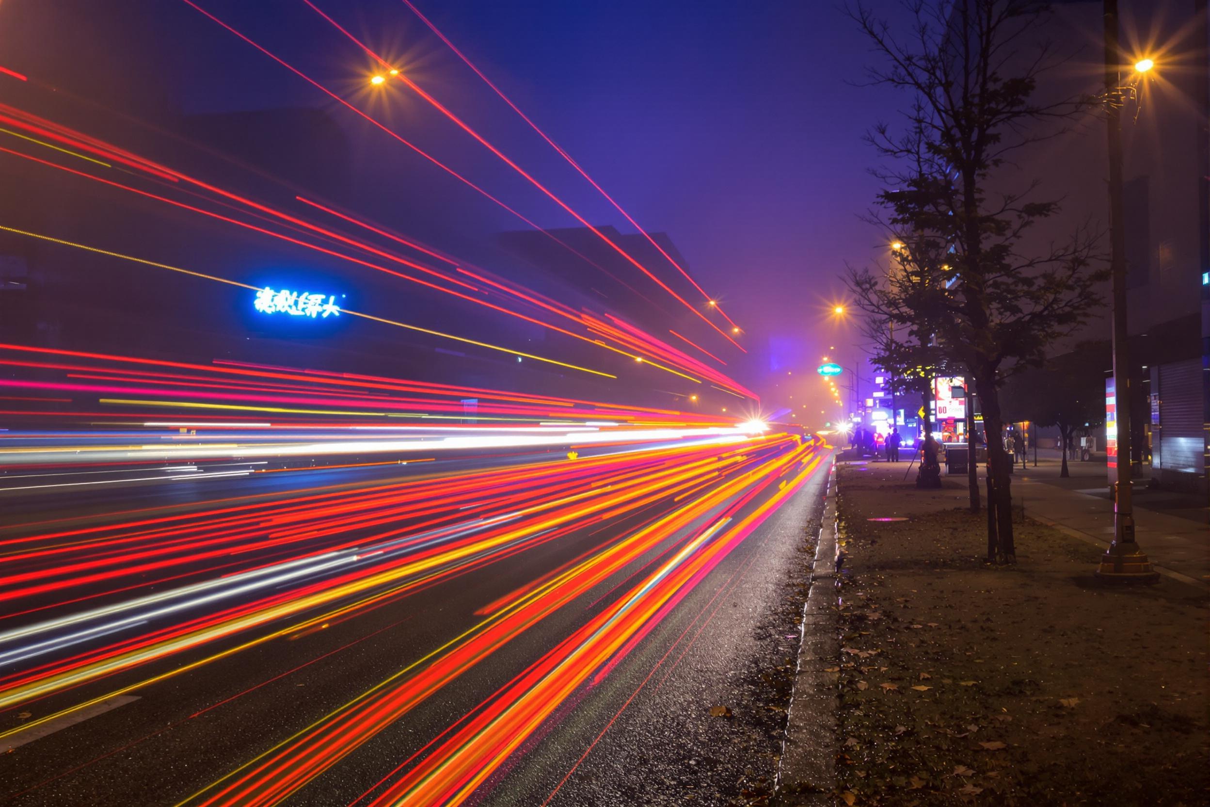 Foggy City Night with Vibrant Light Trails