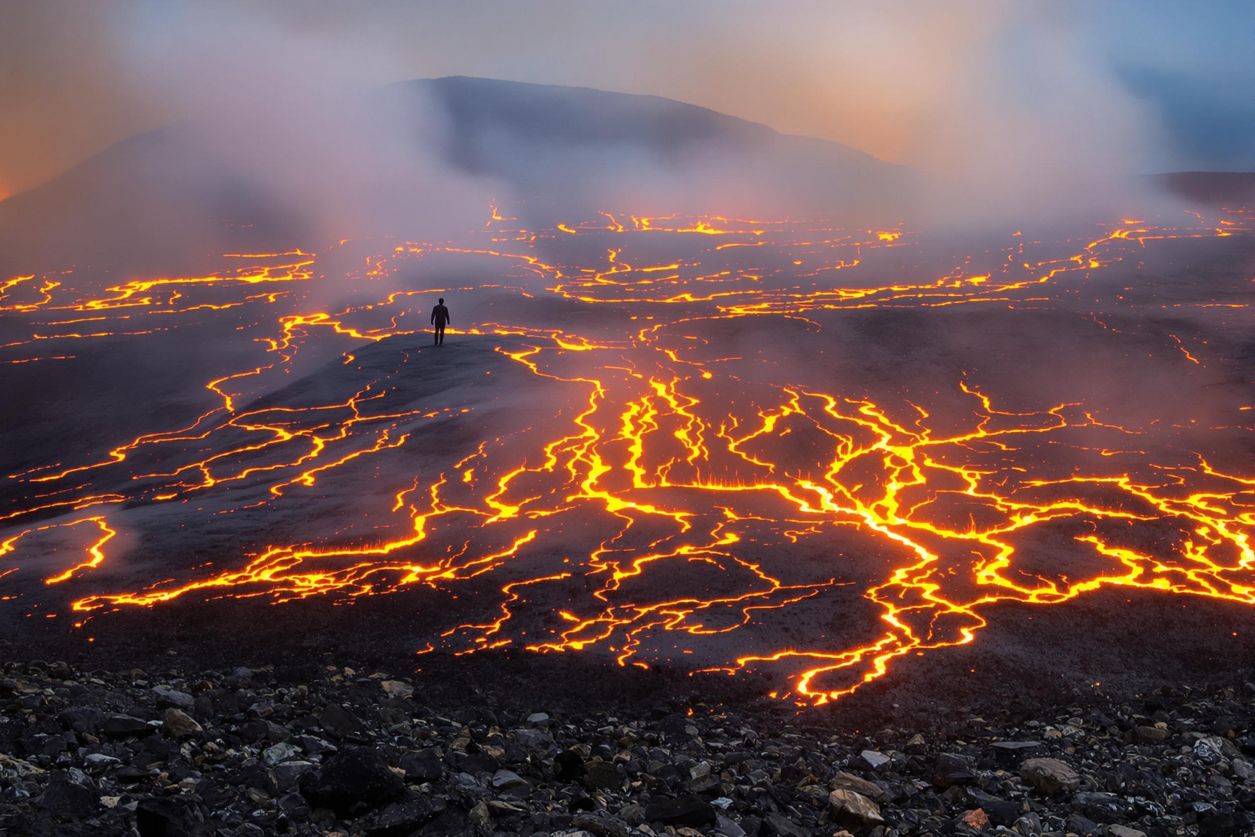 Solitary trekker amidst volcanic eruption chaos