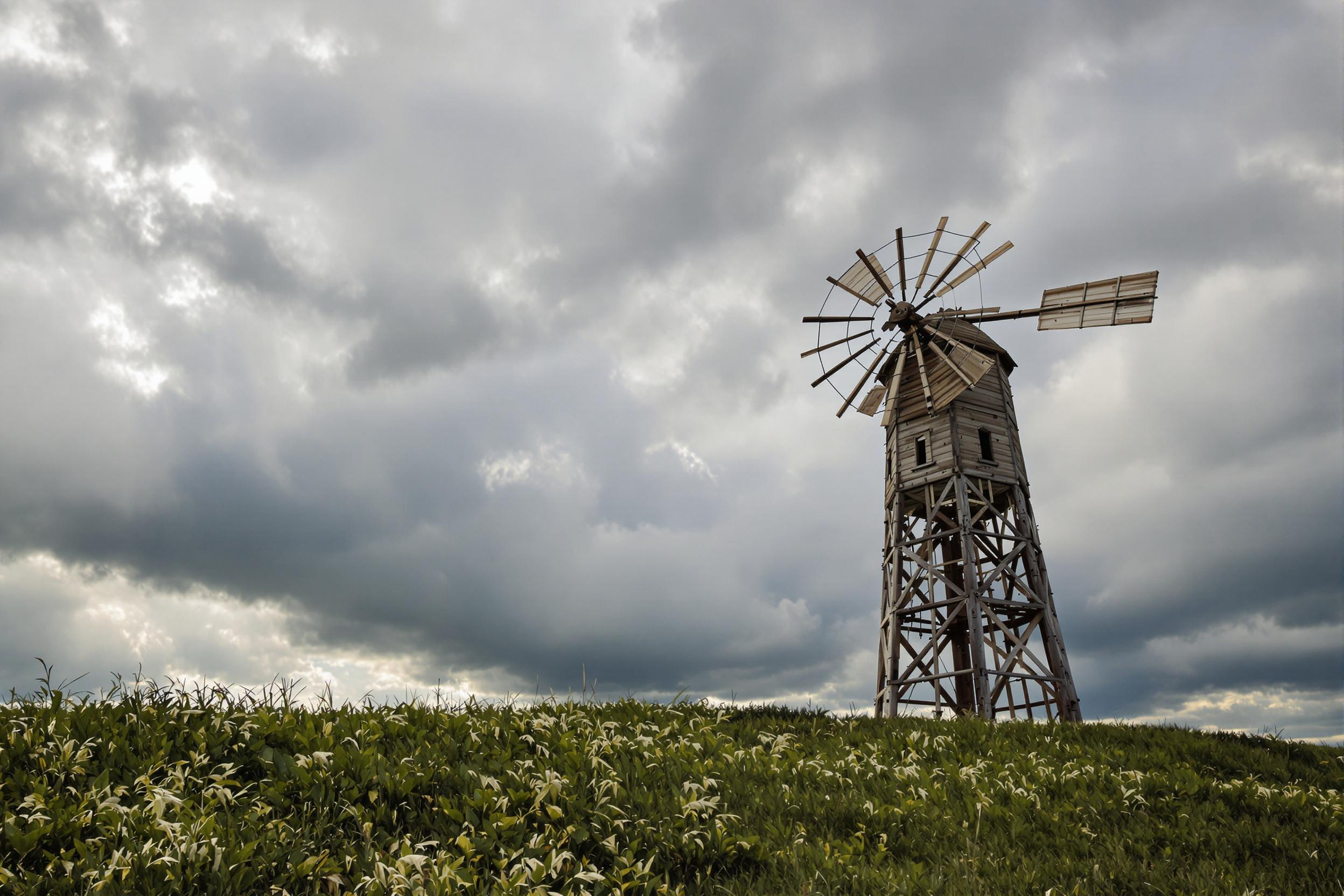 Rustic Windmill Under Stormy Skies